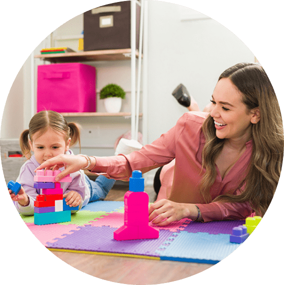 woman and young child playing with blocks